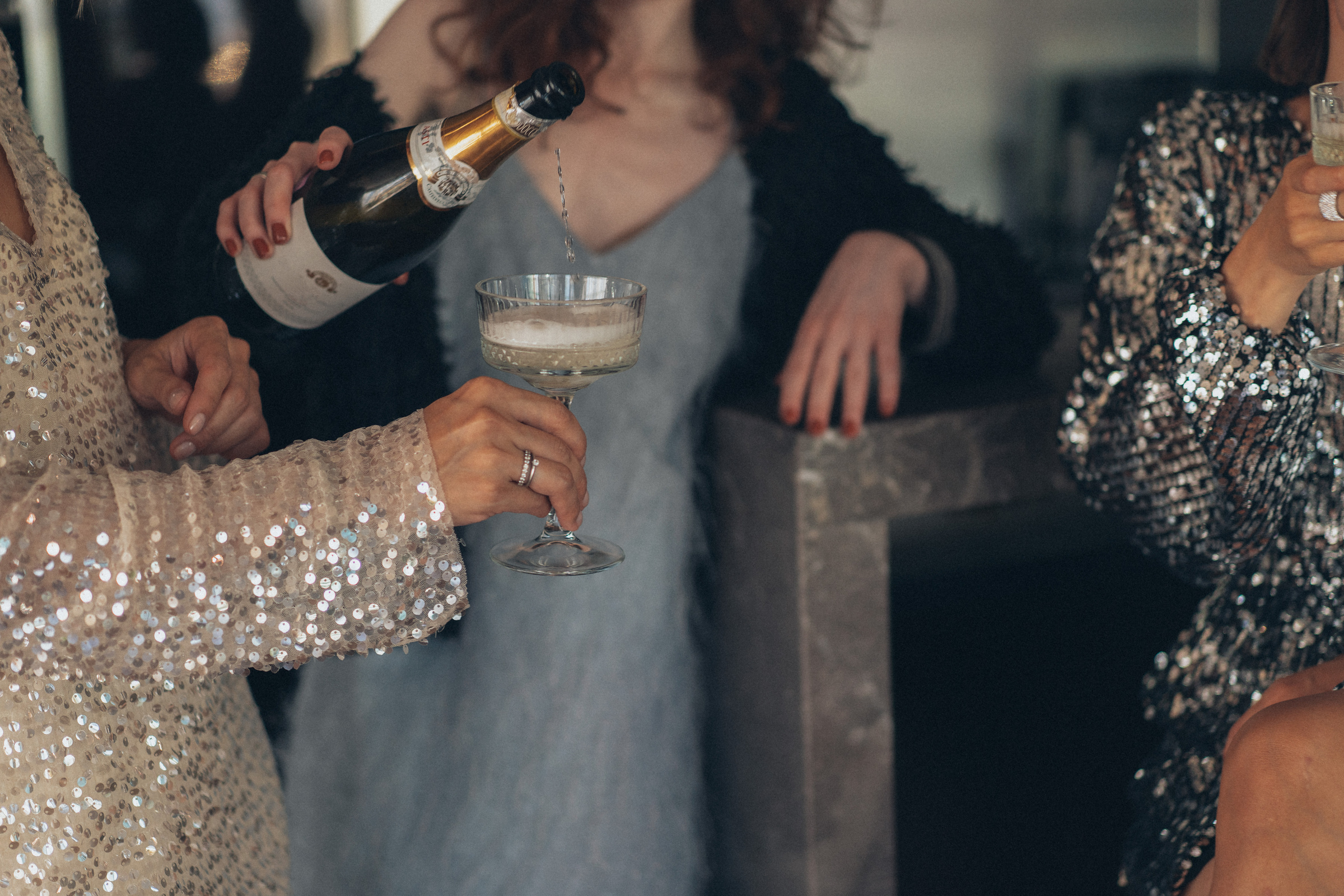 Woman Pouring Champagne on Wineglass